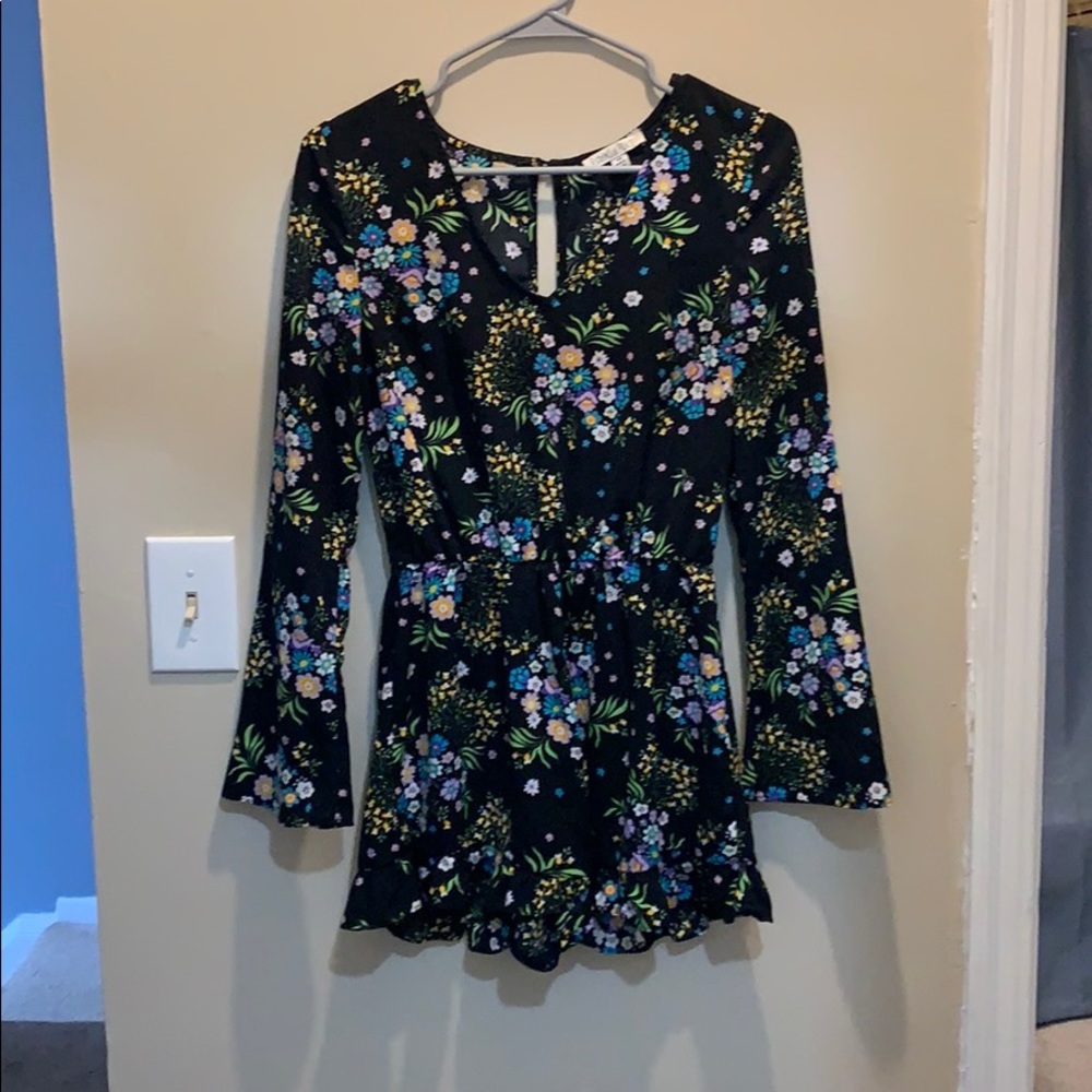Black long sleeve romper with flower designs.
